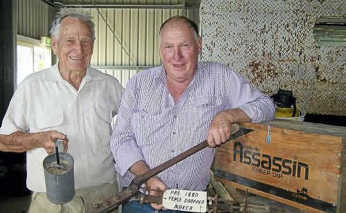Hugh Tindall with auctioneer Stuart Bond holding a fence dropper maker, which sold for $350. Hugh Tindall with auctioneer Stuart Bond holding a fence dropper maker, which sold for $350.